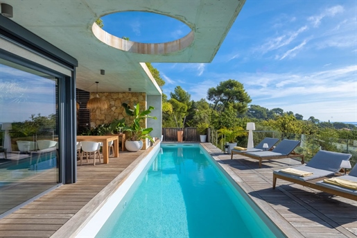 Nestled in a verdant setting, the property is an exceptional contemporary work of art in a sought-af